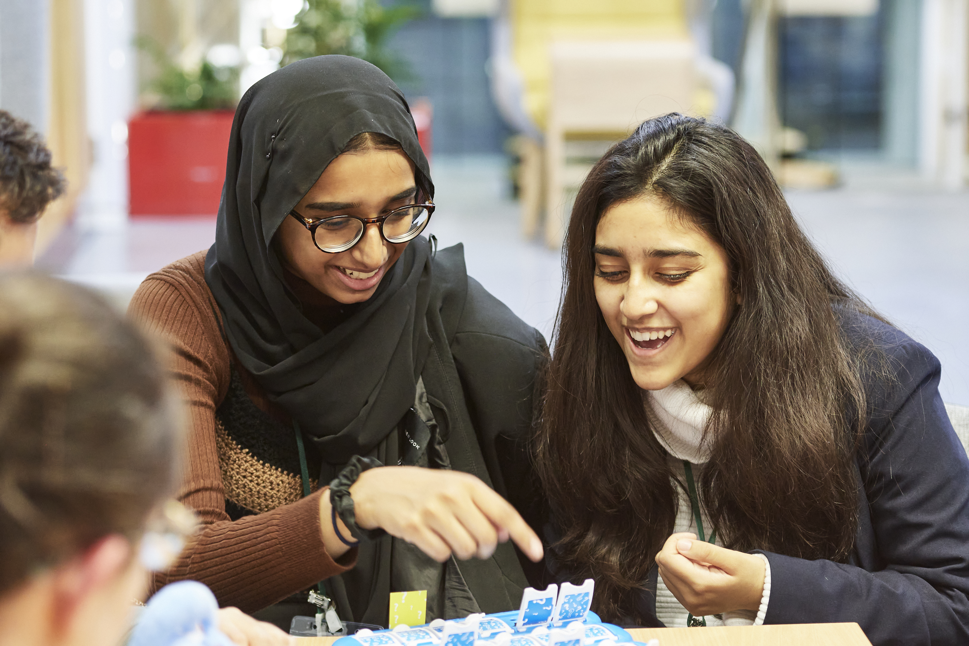 Two students playing a scientific 'guess who' game