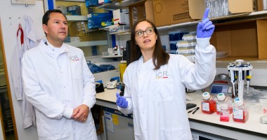 lab tour 380x200px A man and a woman wearing lab coats look around a laboratory