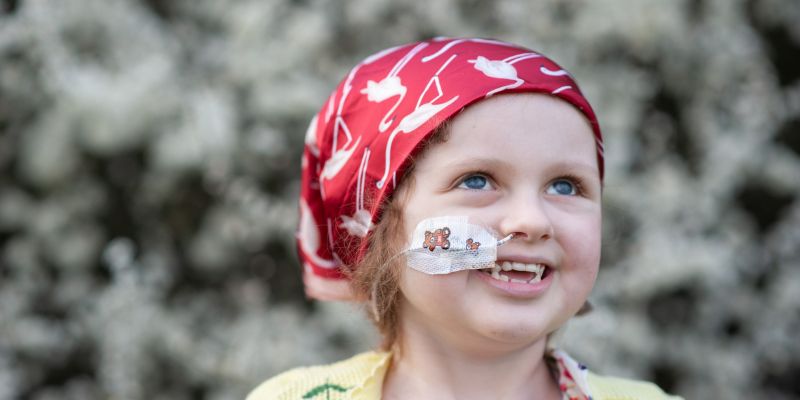 Siobhan of Siobhan's Superstar Legacy Portrait of Siobhan with nasal cannula, wearing a red headscarf